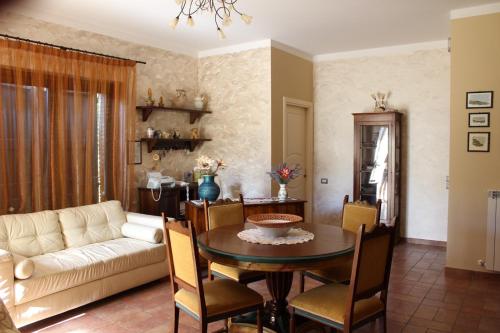 a living room with a table and a couch at La Sorgente Del Sole in San Severino Marche