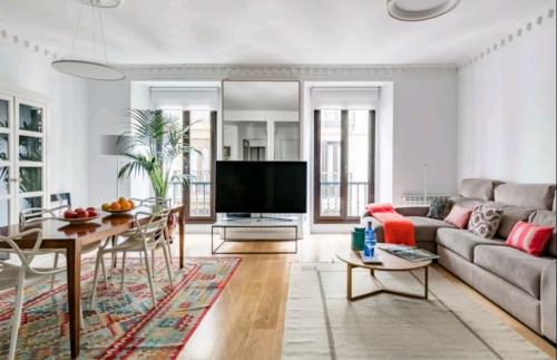 a living room with a couch and a table at Piso en el Corazón de San Sebastián with AC License ESS00262 in Donostia-San Sebastián
