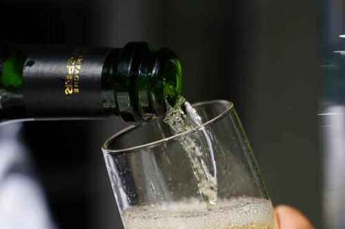 a person is pouring wine into a glass at Logis Hotel Le Blason de Provence in Monteux