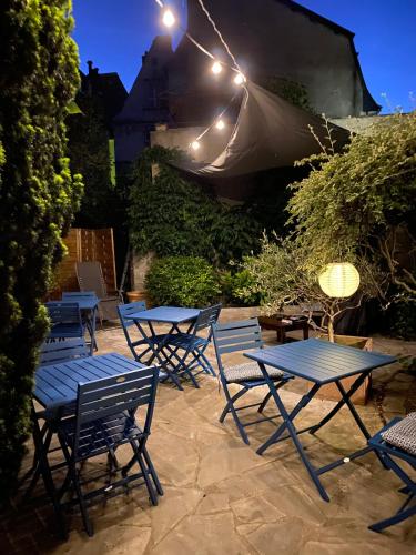 a group of tables and chairs on a patio at night at Hotel Colbert in Tours