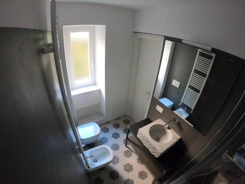 a bathroom with a toilet and a sink and a mirror at La Scialuppa in Camogli