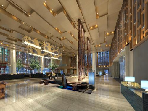 a lobby of a building with a sculpture in the middle at Howard Johnson Neodalle Resort Zhangjiajie in Zhangjiajie