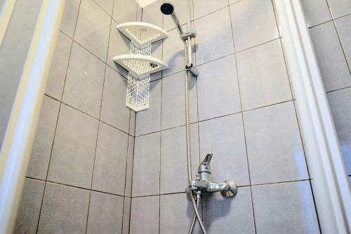a shower with a shower head in a bathroom at Rab City Apartment Greeny in Rab
