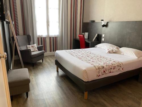 a hotel room with a bed and a chair at Hotel Colbert in Tours