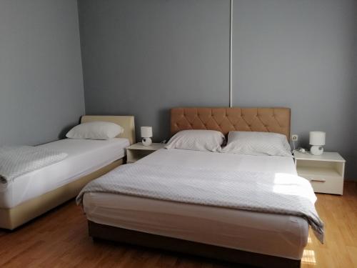 a bedroom with two beds and two night stands at Apartmants Mazoljice in Mostar