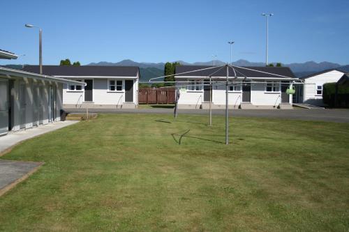 a large yard with a basketball hoop in front of a building at Levin TOP 10 Holiday Park in Levin