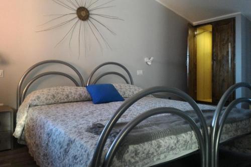 a bedroom with two beds with a blue pillow at Corona Bed & Breakfast in Sardara