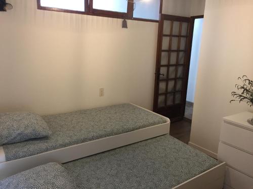 a small bedroom with a bed and a door at Chez Marius Gordes Vue panoramique sur luberon in Gordes