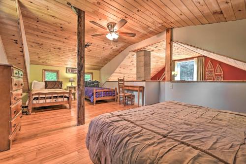 een slaapkamer met een bed en een plafondventilator bij Cabin in the Untouched Woods - 3 Miles to Ski in Jay