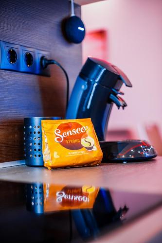 a bag of orange chips on a counter next to a coffee maker at Luxury Smart Apartments in Szeged