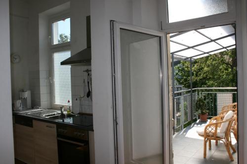 a kitchen with a sliding glass door leading to a balcony at Kleiner Herrenhof in Worms