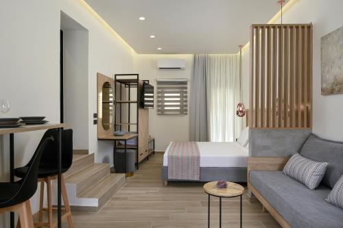 a hotel room with a bed and a couch at Casa D'Irene Deluxe Hotel in Falasarna