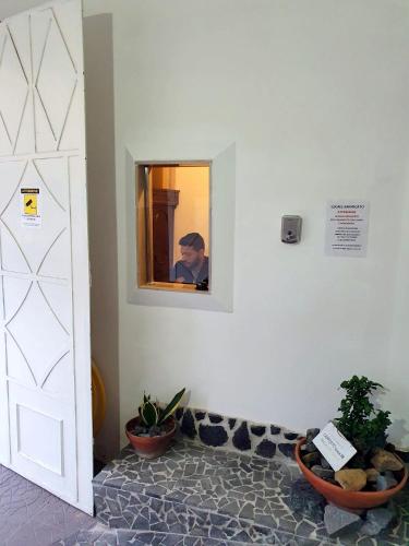 a man taking a picture in a mirror in a room at B&B Cappotto civico 48 in Pompei