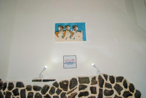 a room with a leopard blanket and a poster on the wall at B&B Cappotto civico 48 in Pompei