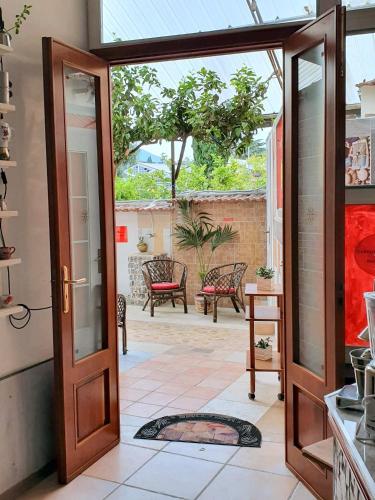 an open door leading to a patio with chairs at B&B Cappotto civico 48 in Pompei