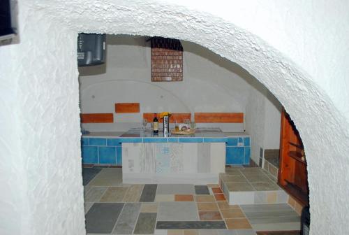 a kitchen with a white and blue counter in a room at B&B Cappotto civico 48 in Pompei