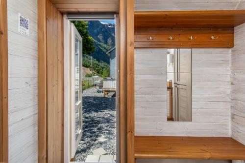 a door to the outside of a house with a view at Tiny house with terrace in Flåm
