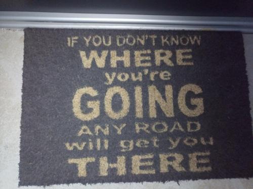 a sign that says if you dont know where youre going any road will get at apartma "happy Scotts" in Starše