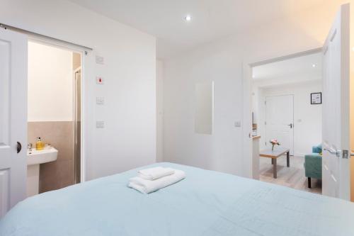 a white bedroom with a white bed with a mirror at Smart Apartment Close2City in Leicester