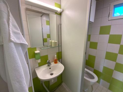 a bathroom with a sink and a toilet at Rauhan Marinella Village in Imatra