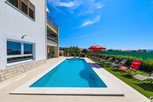 a swimming pool in the backyard of a house at Villa Olivia Trogir in Trogir