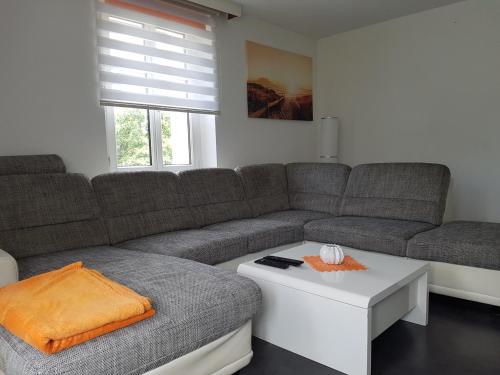a living room with a couch and a coffee table at Green Hill Apartments - Feldkirch in Feldkirch