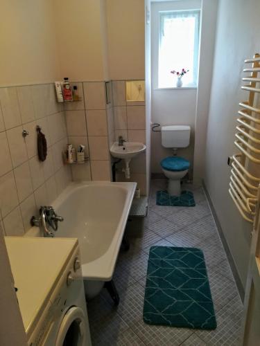 a bathroom with a tub and a toilet and a sink at Leśna Polana in Lasowka