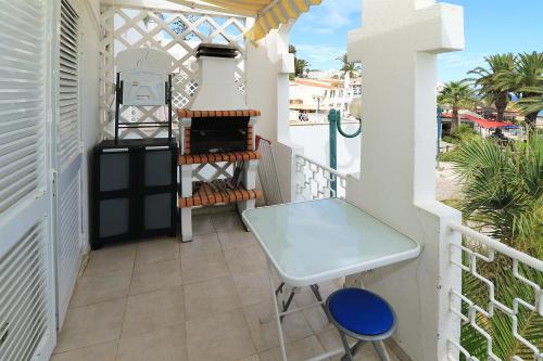 a balcony with a table and a grill at venha nadar a oura in Albufeira