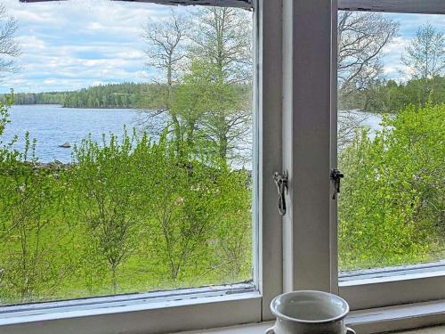 a window with a view of a lake at 7 person holiday home in LMEDBODA in Älmeboda