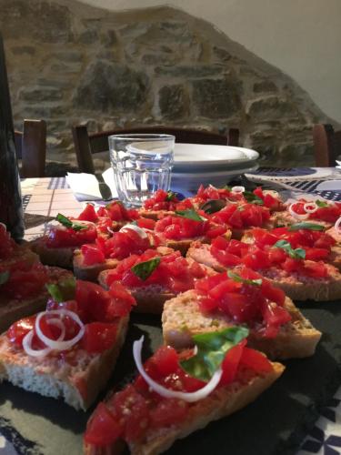 a table with a bunch of pizzas on it at Casina Della Burraia in Subbiano