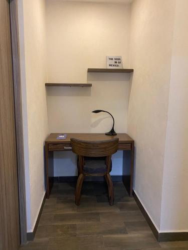 a desk in a hallway with a lamp on it at Suites Rio Elba in Mexico City