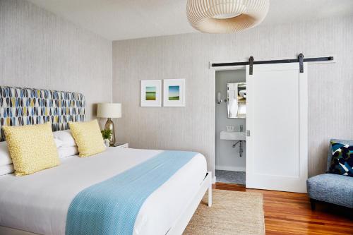 a bedroom with a large bed and a chair at The Attwater in Newport