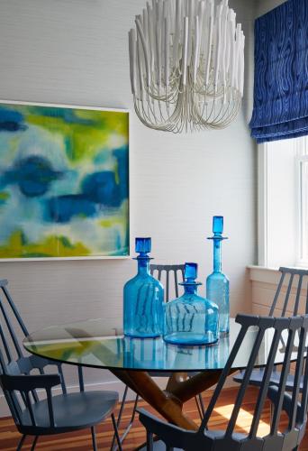 a dining room table with blue glass bottles on it at The Attwater in Newport