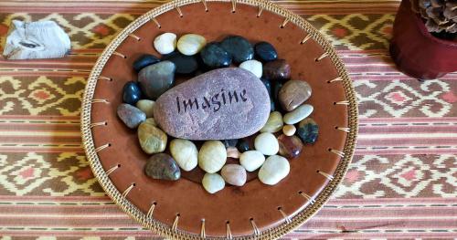 a bowl filled with rocks and a rock with the wordmology on it at 2 Cranes Inn - Zion in Rockville