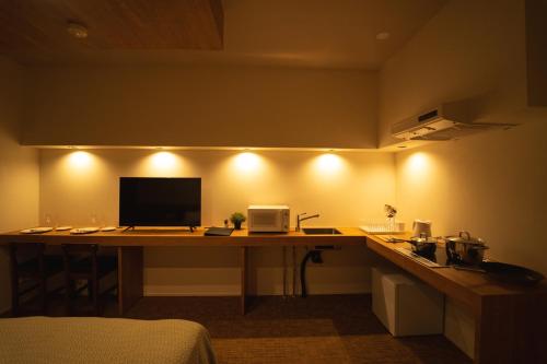 a room with a desk with a computer on it at HIT Tenjin in Fukuoka
