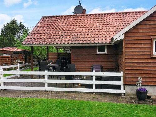 a house with a white fence in front of it at 5 person holiday home in Middelfart in Middelfart
