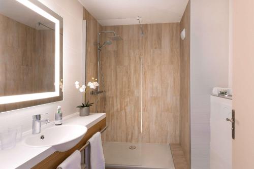 a bathroom with a sink and a shower at Best Western Les Bains Hotel et SPA in Perros-Guirec