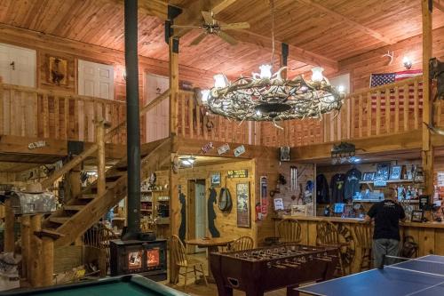 a chandelier in a restaurant with a pool table at lake guest ranch in Devils Tower
