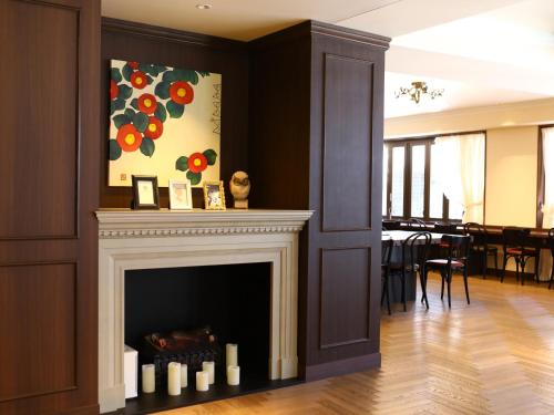 a fireplace in a living room with a painting on the wall at Hotel Wing International Select Ikebukuro in Tokyo