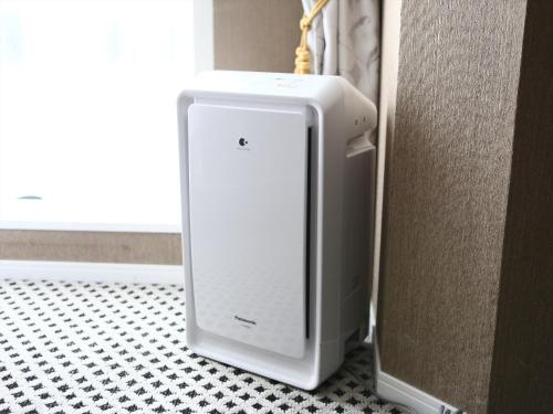 a white refrigerator sitting on the floor next to a wall at APA Hotel Hiroshima Ekimae Ohashi in Hiroshima