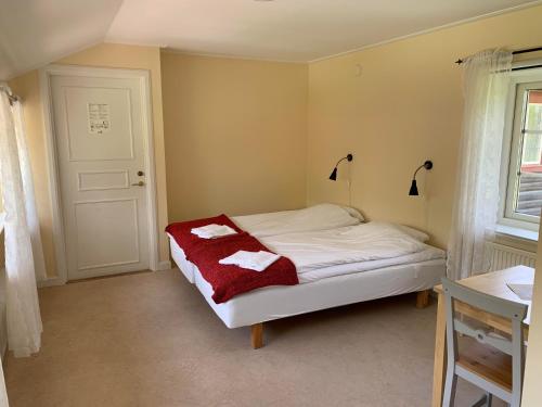 a bedroom with a bed with two towels on it at Leksands Folkhögskola in Leksand