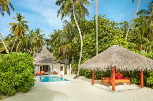 a villa with a swimming pool and a resort at Sun Siyam Vilu Reef with Free Transfer in Dhaalu Atoll