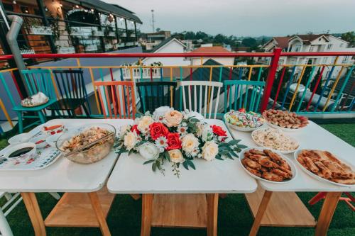 a table with plates of food and flowers on it at Anh Trang Homestay in Da Lat