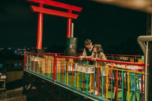a man and a woman standing on a ride at Anh Trang Homestay in Da Lat