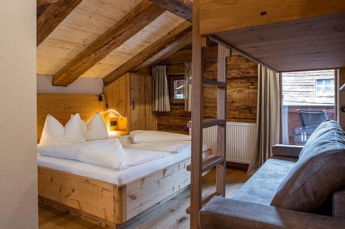 una camera da letto con un grande letto in una camera in legno di Christernhof a Maria Alm am Steinernen Meer