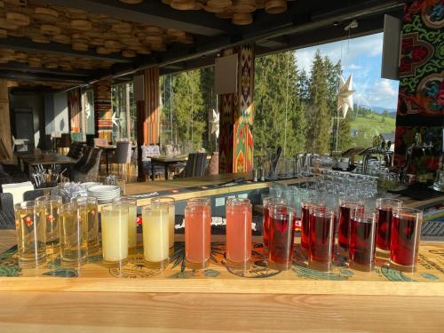 a bunch of glasses sitting on a counter with drinks at SPA HOTEL Gora in Bukovel