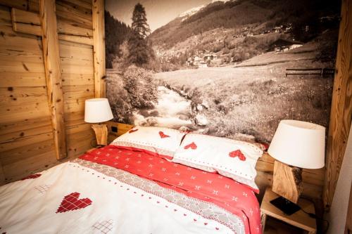 a bedroom with a bed with two lamps on it at Mas dei Bati in Pracorno di Rabbi