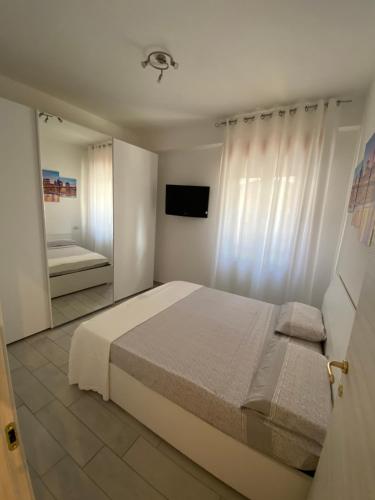 a bedroom with a large bed and a mirror at Il grottino Gargano home in Rodi Garganico