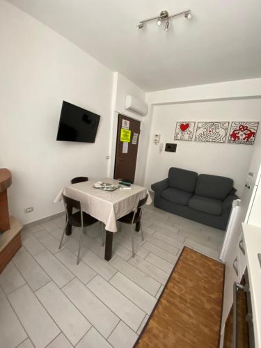a living room with a table and a couch at Terrazza mare home in Rodi Garganico