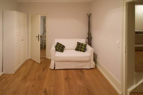 a white couch with two pillows sitting in a living room at Wohnung im Herzen von Ludwigsburg in Ludwigsburg